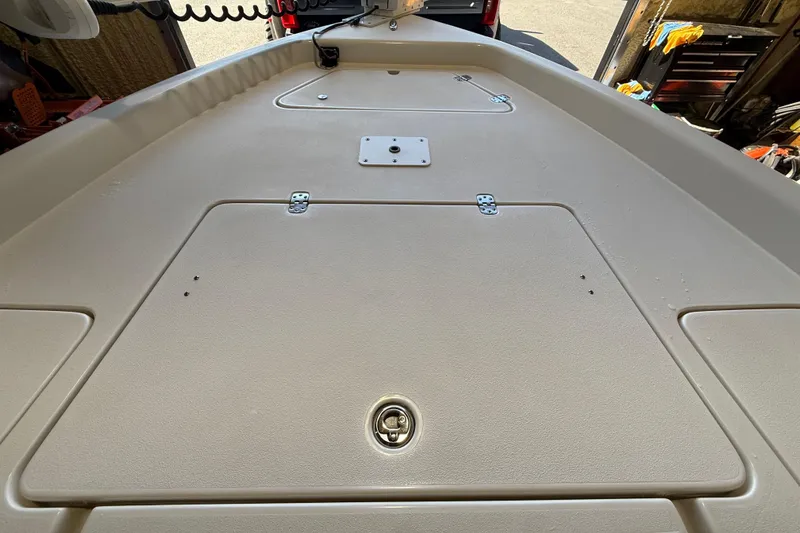 Slide: The Image of 2018 ShearWater 23LTZ boat deck with storage compartments and latch. - 44
