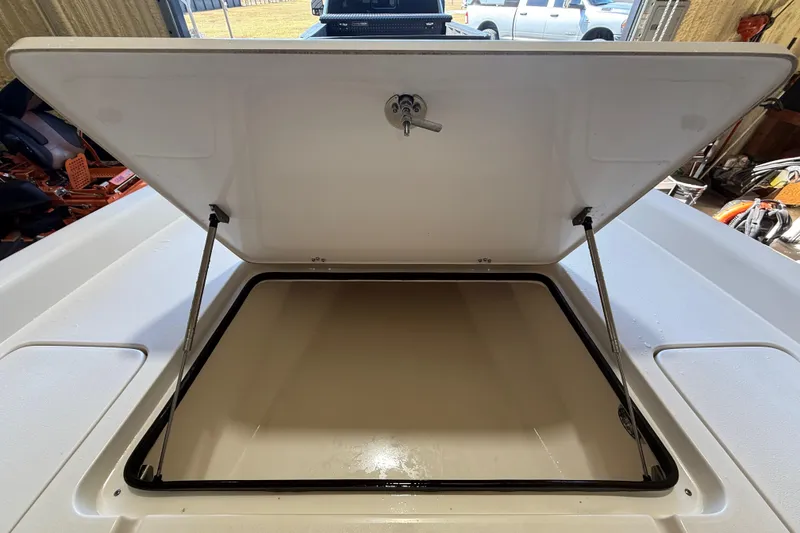 Slide: The Image of Open storage compartment on 2018 ShearWater 23LTZ boat, showcasing interior space. - 45