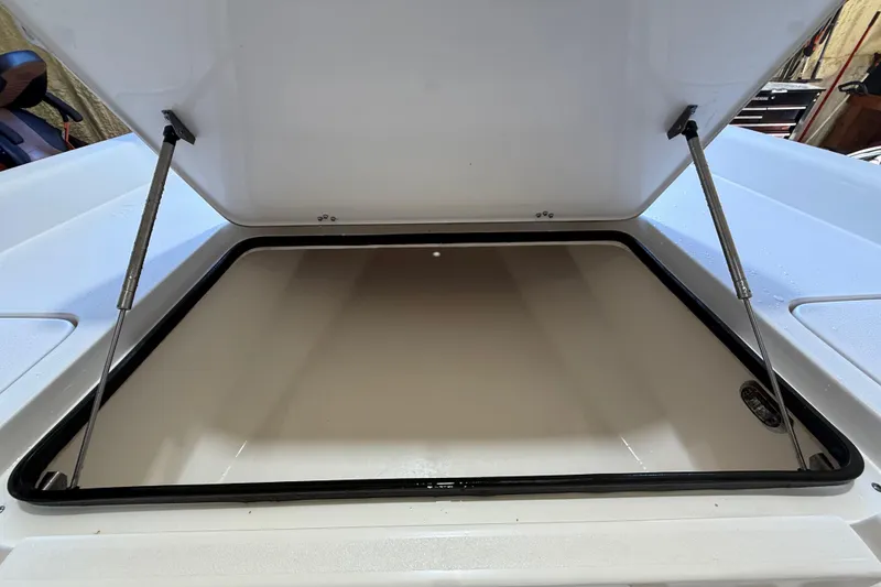 Slide: The Image of Open storage compartment of 2018 ShearWater 23LTZ boat, showcasing interior space. - 46
