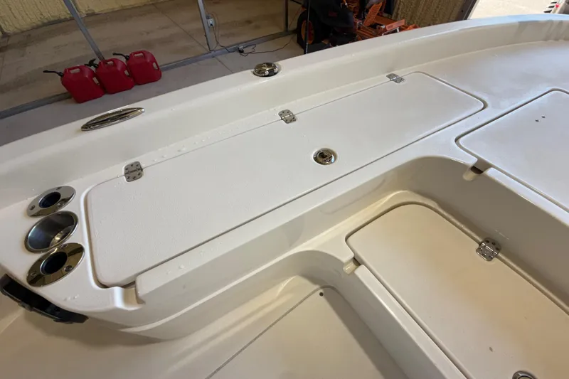 Slide: The Image of 2018 ShearWater 23LTZ boat deck with storage compartments and cup holders. - 47