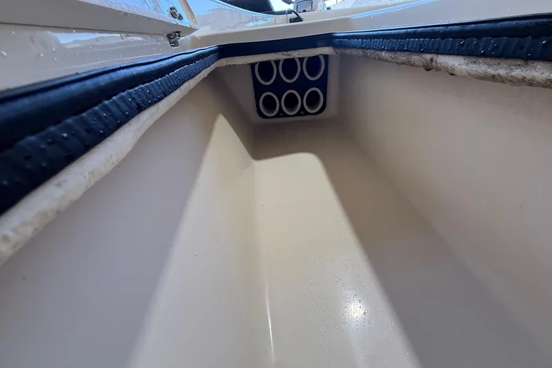 Slide: The Image of Storage compartment of 2018 ShearWater 23LTZ boat, featuring rod holders. - 49
