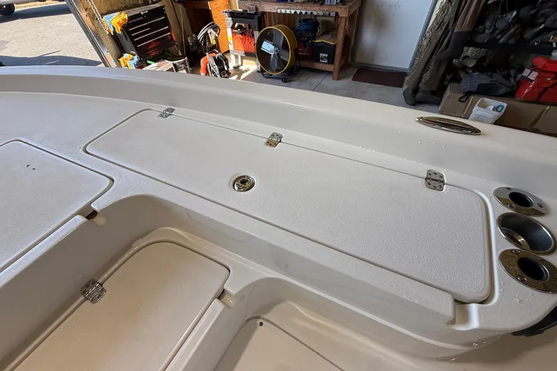 Slide: The Image of 2018 ShearWater 23LTZ boat deck with storage compartments and cup holders. - 51