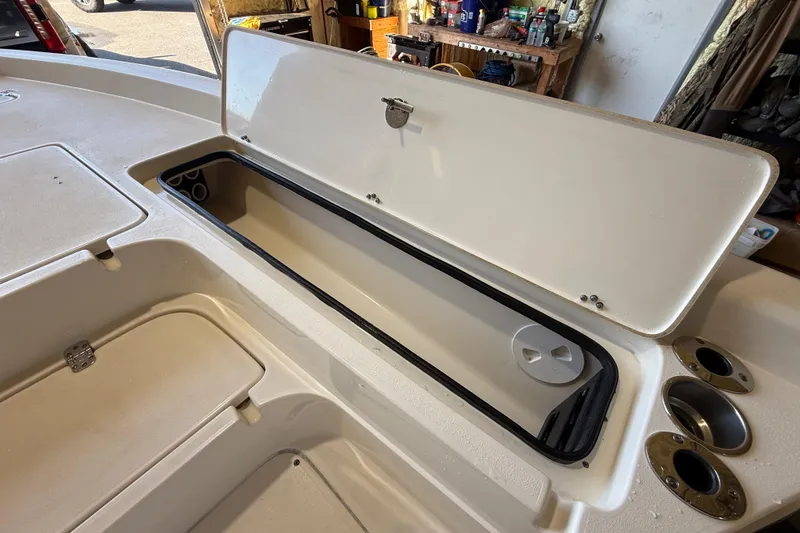 Slide: The Image of Open storage compartment on 2018 ShearWater 23LTZ boat, showcasing interior space. - 52