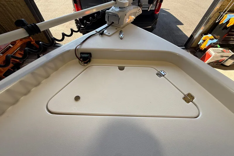 Slide: The Image of 2018 ShearWater 23LTZ boat deck with storage compartment and mounted equipment. - 55