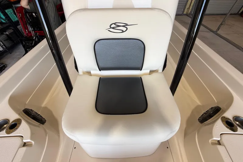 Slide: The Image of 2018 ShearWater 23LTZ boat seat with logo, featuring white and black cushioned design. - 57