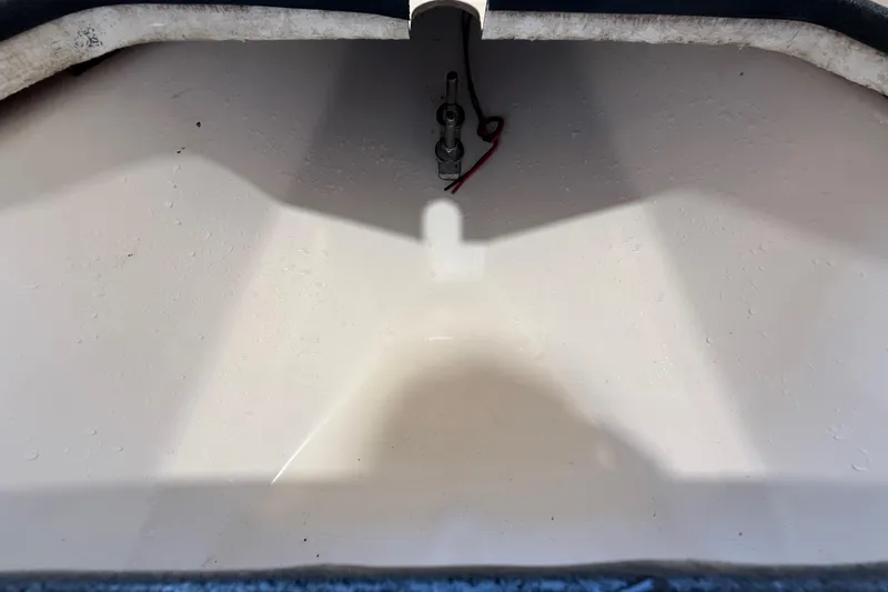 Slide: The Image of 2018 ShearWater 23LTZ boat interior compartment with visible wiring and clean surface. - 59