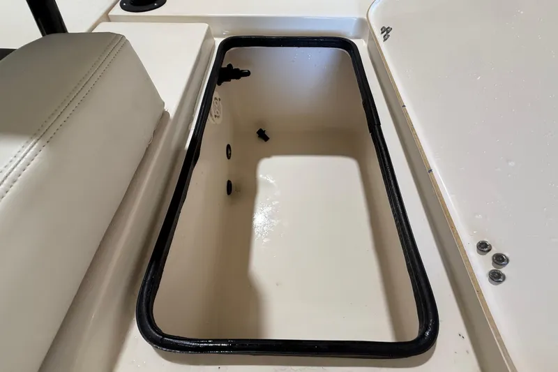 Slide: The Image of Open storage compartment on 2018 ShearWater 23LTZ boat, featuring a clean interior. - 64