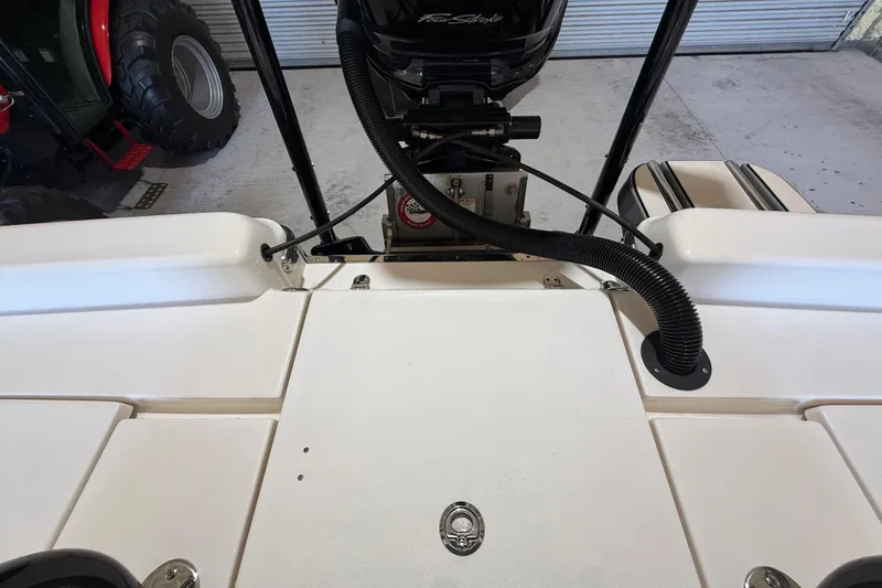 Slide: The Image of 2018 ShearWater 23LTZ boat deck with motor and storage compartment. - 65