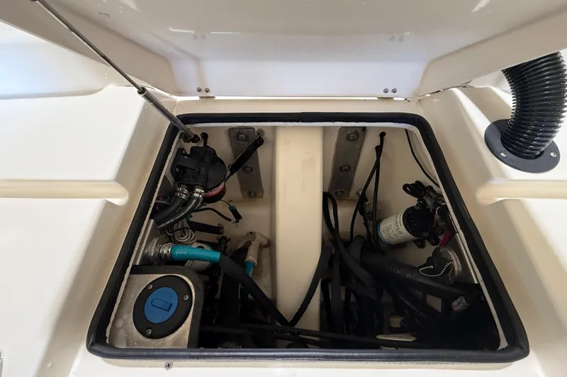 Slide: The Image of Open hatch of 2018 ShearWater 23LTZ boat showing internal components and wiring. - 66