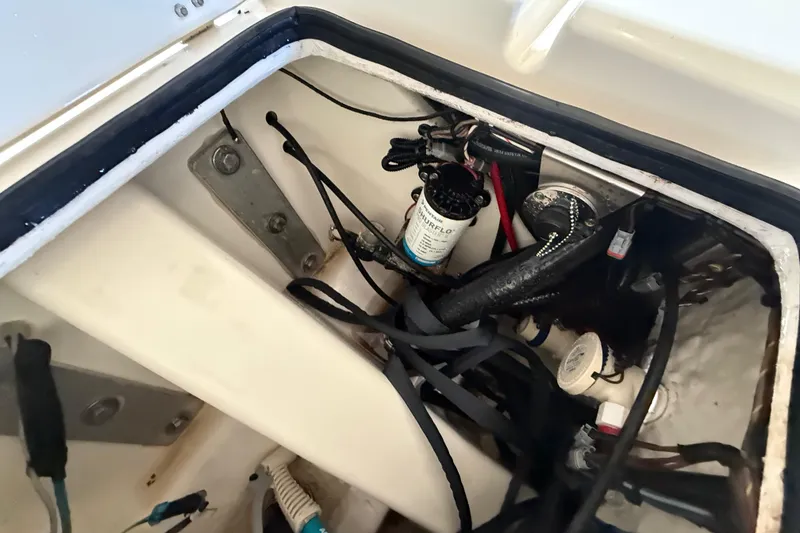 Slide: The Image of 2018 ShearWater 23LTZ boat compartment with wiring and pump system. - 67