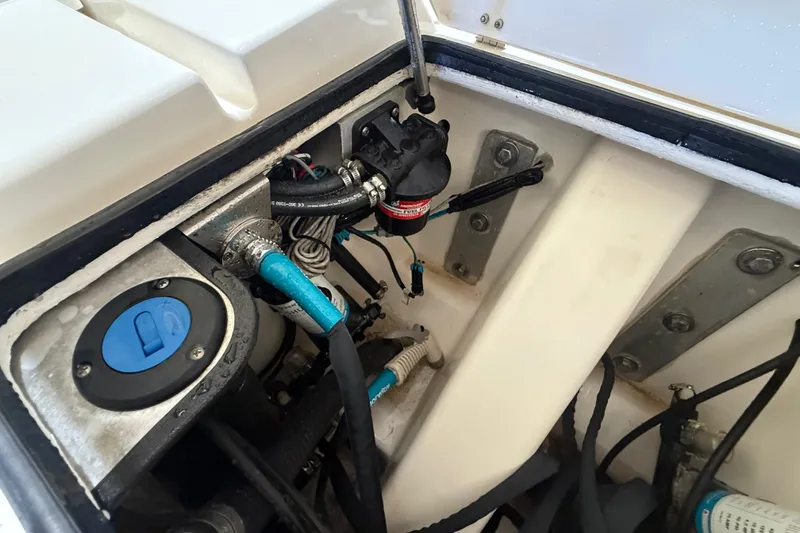 Slide: The Image of Engine compartment of a 2018 ShearWater 23LTZ boat, showing hoses and components. - 68