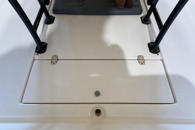 Slide: The Image of 2018 ShearWater 23LTZ boat deck with storage hatch and black railings. - 69
