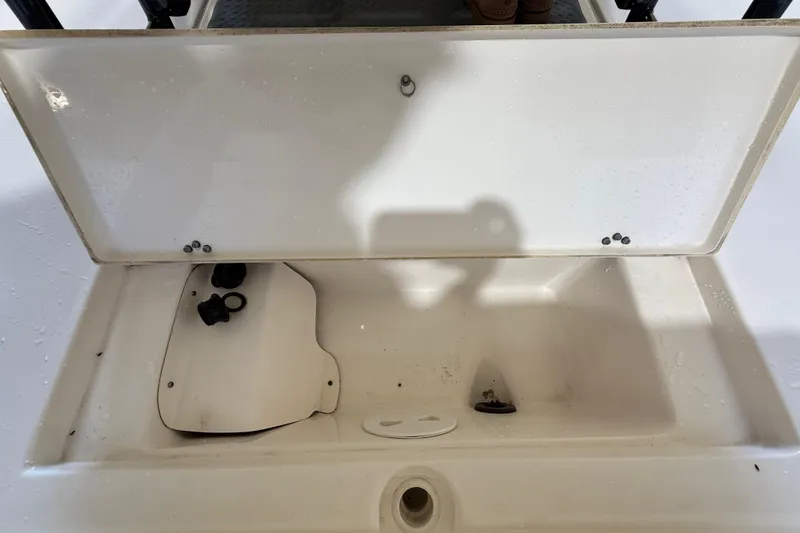 Slide: The Image of Open storage compartment of 2018 ShearWater 23LTZ boat, showing interior details. - 70