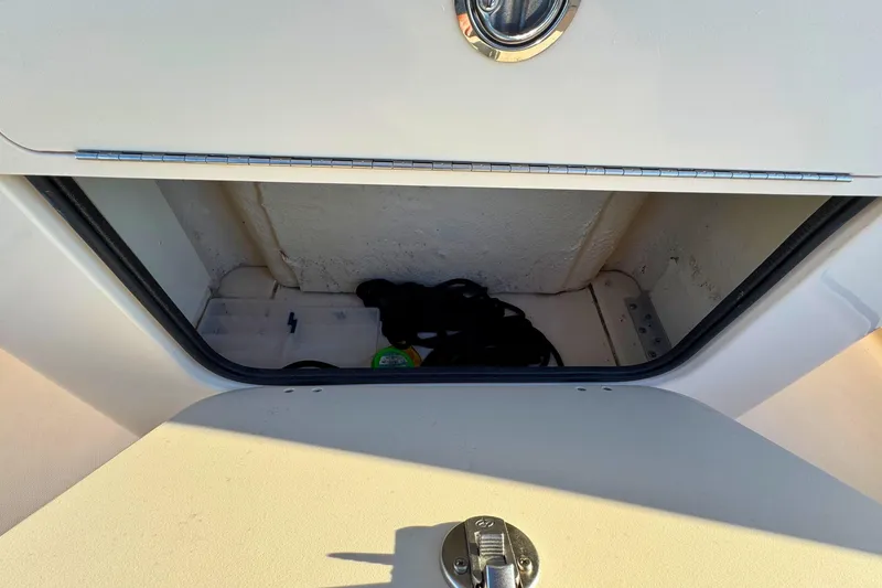 Slide: The Image of Storage compartment on 2024 Grady-White Fisherman 216 boat, featuring secure latch. - 14