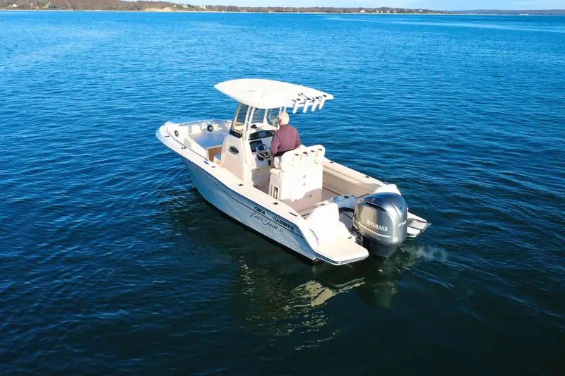 Slide: The Image of 2024 Grady-White Fisherman 216 boat on open water, rear view. - 3