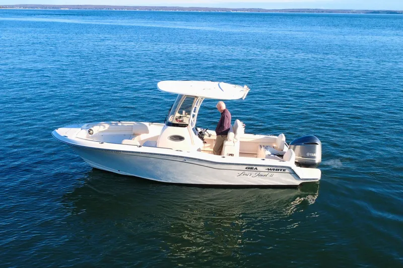 Slide: The Image of 2024 Grady-White Fisherman 216 boat on calm blue water. - 4