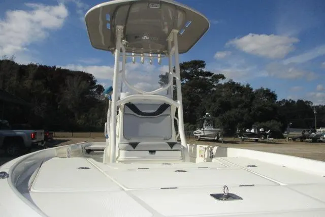 Slide: The Image of 2021 Skeeter SX240 boat with T-top, spacious deck, and clear sky background. - 3
