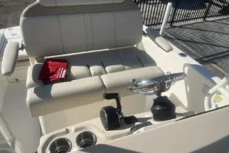 Slide: The Image of 2024 Boston Whaler 220 Dauntless boat interior with seating and controls. - 10