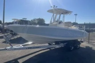 Slide: The Image of 2024 Boston Whaler 220 Dauntless boat on trailer under clear sky. - 3