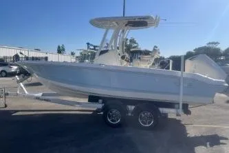 Slide: The Image of 2024 Boston Whaler 220 Dauntless boat on trailer, side view, sunny day. - 4