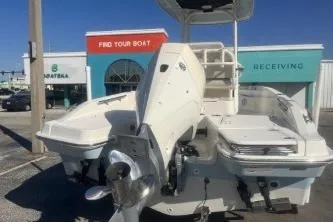 Slide: The Image of 2024 Boston Whaler 220 Dauntless boat displayed at a dealership. - 5