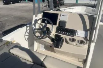 Slide: The Image of 2024 Boston Whaler 220 Dauntless boat console with steering wheel and controls. - 7