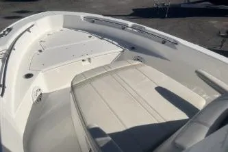 Slide: The Image of 2024 Boston Whaler 220 Dauntless boat interior with seating and storage compartments. - 8