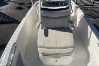 Slide: The Image of 2024 Boston Whaler 220 Dauntless boat interior with cushioned seating and console. - 9