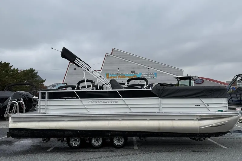 The Image of 2025 Berkshire 24CL 2.75 LE pontoon boat parked outdoors on a cloudy day. - 1