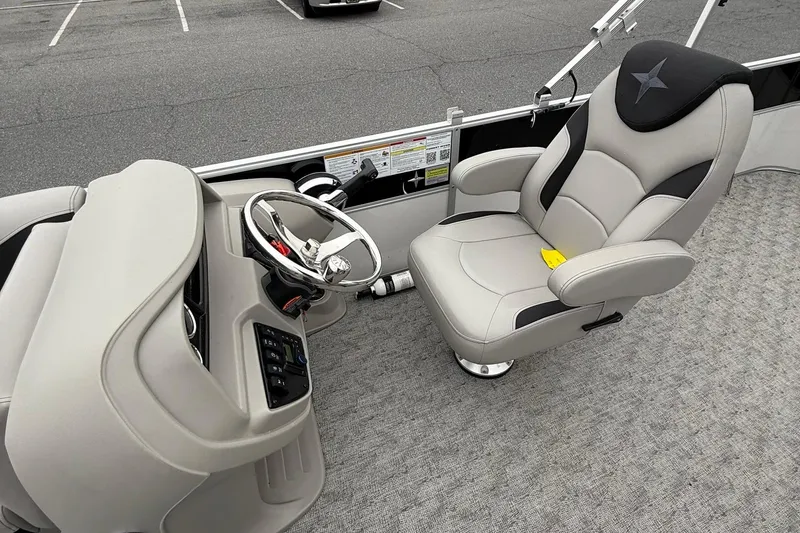 Slide: The Image of 2025 Berkshire 24CL 2.75 LE boat interior with steering wheel and captain's chair. - 10