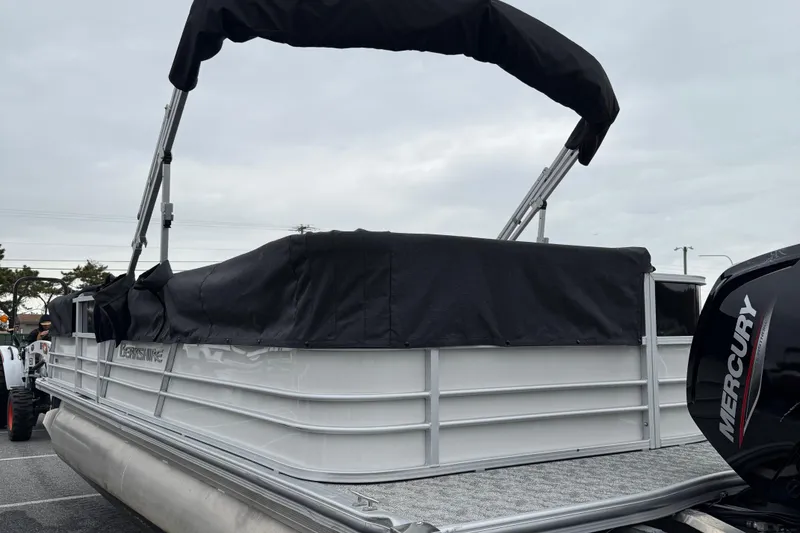 Slide: The Image of 2025 Berkshire 24CL 2.75 LE pontoon boat with Mercury engine, covered and docked. - 3
