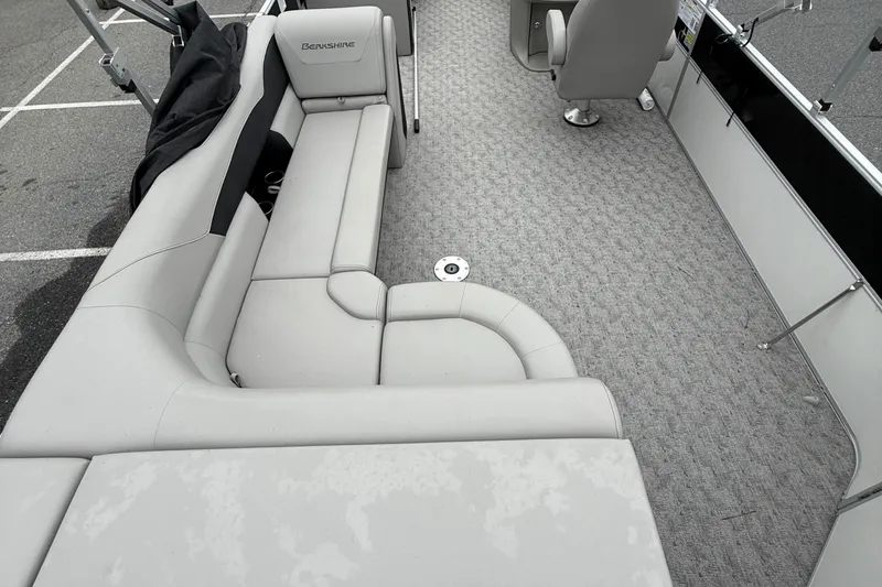 Slide: The Image of 2025 Berkshire 24CL 2.75 LE pontoon boat interior with gray seating and carpet. - 8