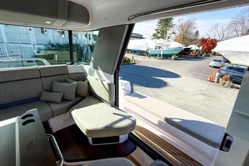 Slide: The Image of 2024 Axopar 45 XC Cross Cabin interior with modern seating and large windows. - 12