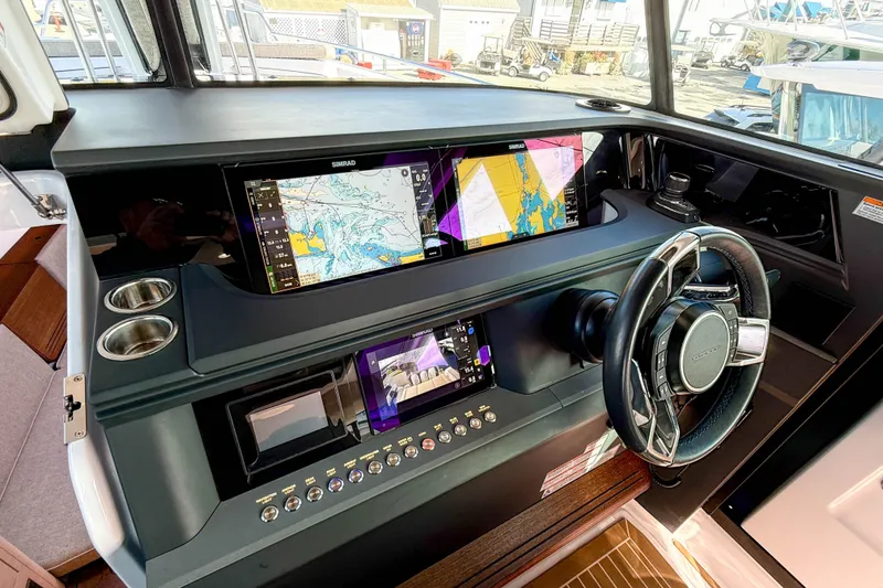 Slide: The Image of 2024 Axopar 45 XC Cross Cabin dashboard with navigation screens and steering wheel. - 15