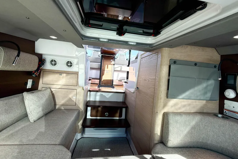 Slide: The Image of Interior of 2024 Axopar 45 XC Cross Cabin, featuring modern seating and wood accents. - 23