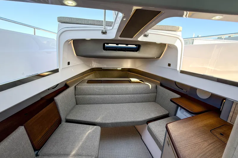 Slide: The Image of 2024 Axopar 45 XC Cross Cabin interior with modern seating and wooden accents. - 26
