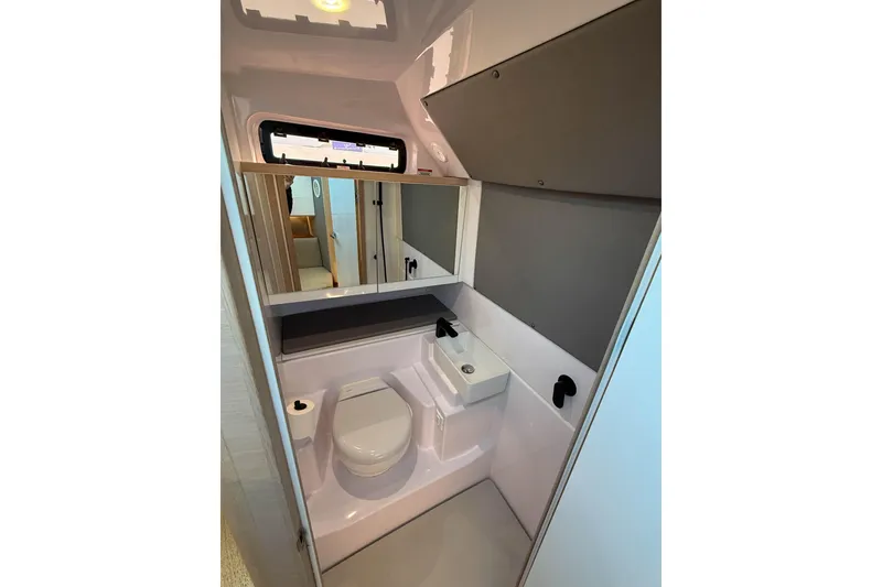 Slide: The Image of 2024 Axopar 45 XC Cross Cabin bathroom with modern fixtures and compact design. - 30