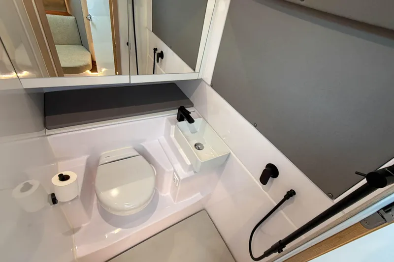 Slide: The Image of 2024 Axopar 45 XC Cross Cabin bathroom with modern fixtures and compact design. - 31