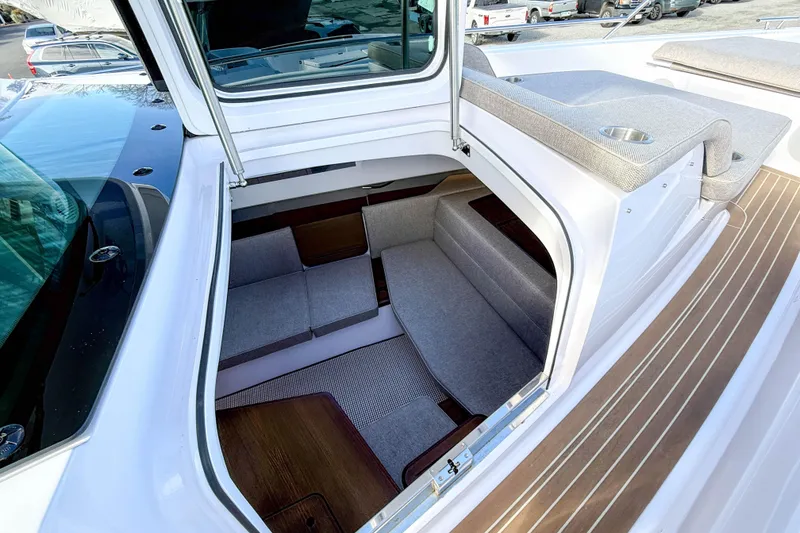 Slide: The Image of 2024 Axopar 45 XC Cross Cabin interior with seating and wood accents. - 33