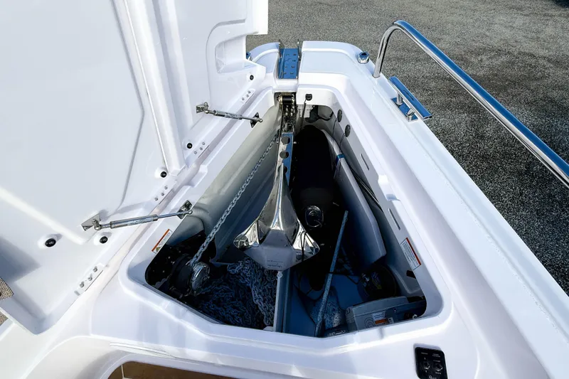 Slide: The Image of Anchor compartment of 2024 Axopar 45 XC Cross Cabin boat, featuring storage and equipment. - 38