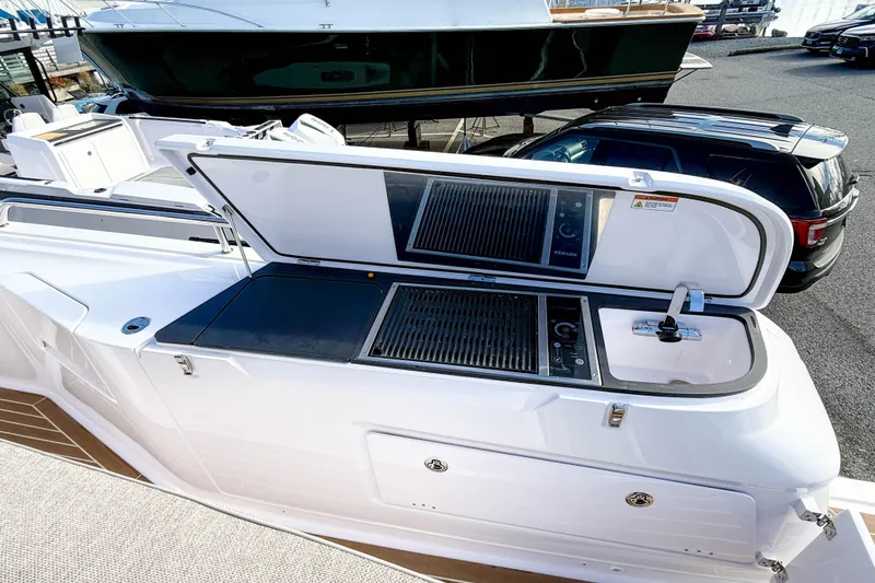Slide: The Image of Outdoor kitchen on 2024 Axopar 45 XC Cross Cabin boat with grill and sink. - 39