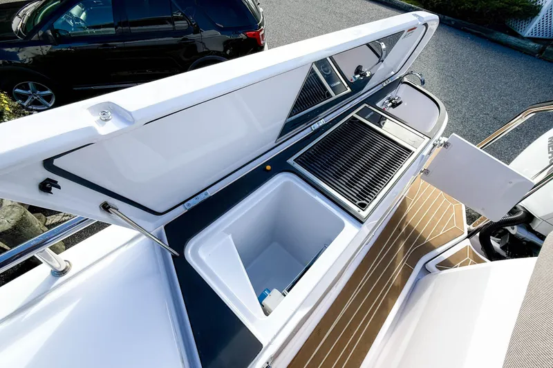 Slide: The Image of 2024 Axopar 45 XC Cross Cabin outdoor kitchen with grill and sink. - 40