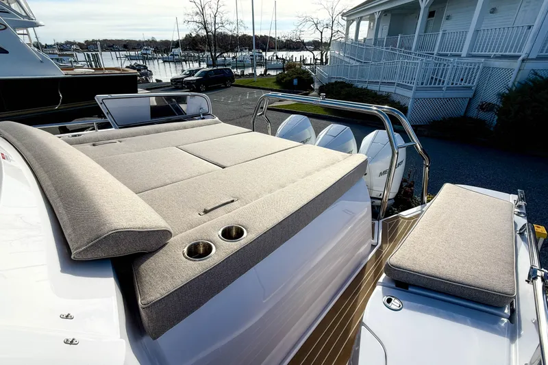 Slide: The Image of 2024 Axopar 45 XC Cross Cabin with cushioned sun deck and triple outboard engines. - 6