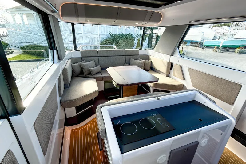 Slide: The Image of 2024 Axopar 45 XC Cross Cabin interior with modern seating and dining area. - 8