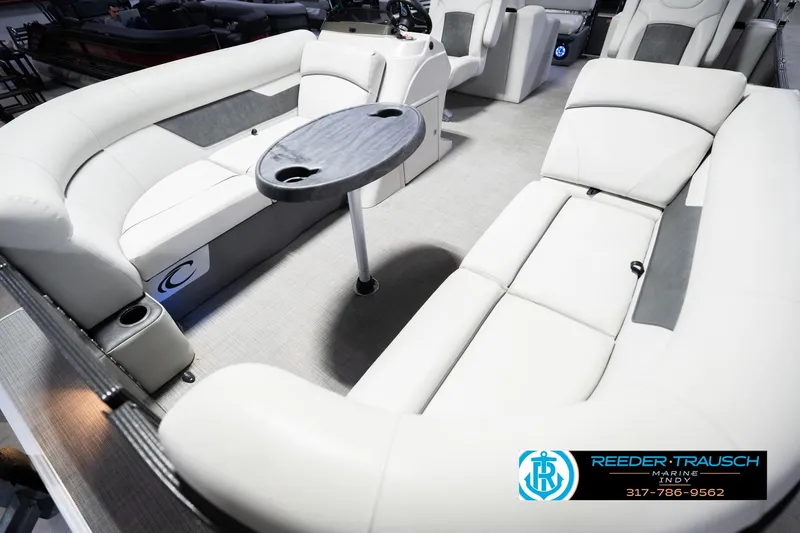 Slide: The Image of 2021 Crest SLRC 220 boat interior with plush seating and table, Reeder-Trausch Marine. - 11
