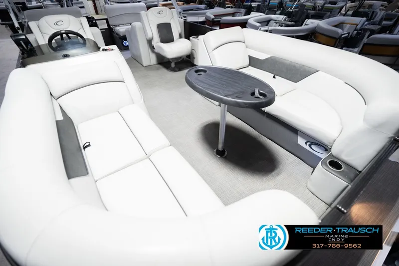 Slide: The Image of Luxurious 2021 Crest SLRC 220 pontoon boat interior with plush seating and table. - 12