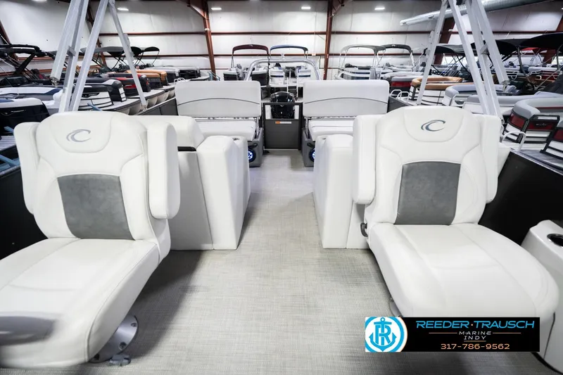 Slide: The Image of 2021 Crest SLRC 220 boat interior with white seating in a showroom. - 16