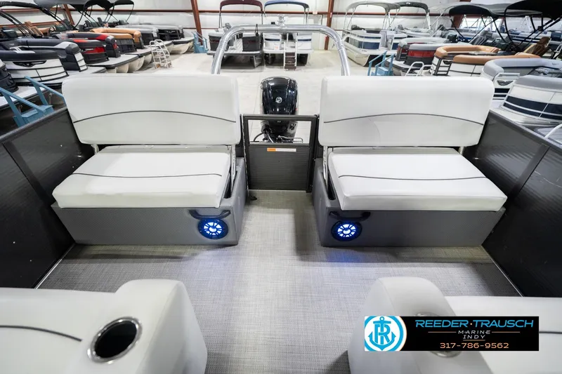 Slide: The Image of Interior of 2021 Crest SLRC 220 pontoon boat with white seating and blue LED lights. - 17