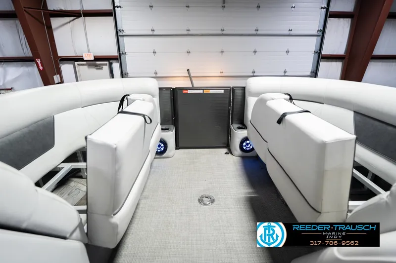 Slide: The Image of Interior of 2021 Crest SLRC 220 boat with white seating and blue-lit speakers. - 22