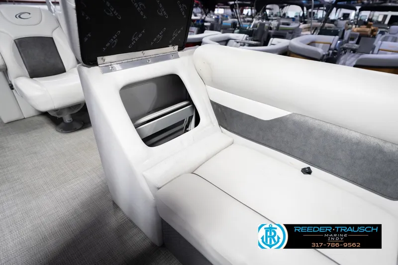 Slide: The Image of Interior of 2021 Crest SLRC 220 boat with white seating and storage compartment. - 24